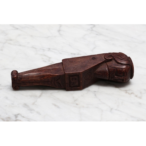 2246 - Nutcrackers - a 19th century oak lever-action figural nut cracker, carved with a portrait of King Ch... 