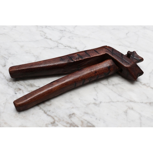 2291 - Nutcrackers - a deciduous timber lever-action nut cracker, of simple cross-over construction, pyrogr... 