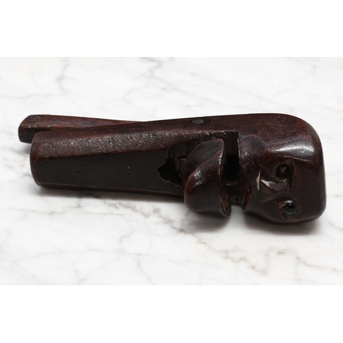 2245 - Nutcrackers - a 19th century novelty lever-action nut cracker, naively carved as a face, 14cm long