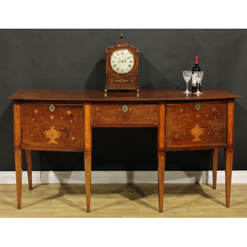 1241 - A 19th century mahogany and marquetry bow-centre sideboard or serving table, oversailing top above t... 