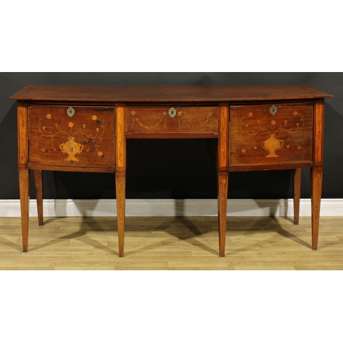 1241 - A 19th century mahogany and marquetry bow-centre sideboard or serving table, oversailing top above t... 