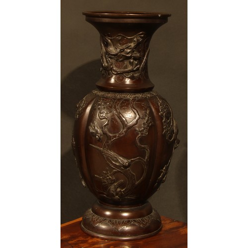 452 - A Japanese bronze baluster floor vase, cast with birds flying amongst blossoming prunus, everted rim... 