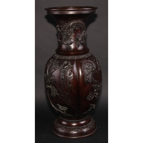 452 - A Japanese bronze baluster floor vase, cast with birds flying amongst blossoming prunus, everted rim... 