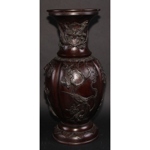 452 - A Japanese bronze baluster floor vase, cast with birds flying amongst blossoming prunus, everted rim... 