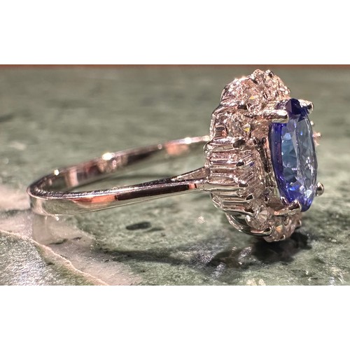 914 - A tanzanite and diamond cluster ring central oval tanzanite approx 1.19ct, surrounded by six baguett... 