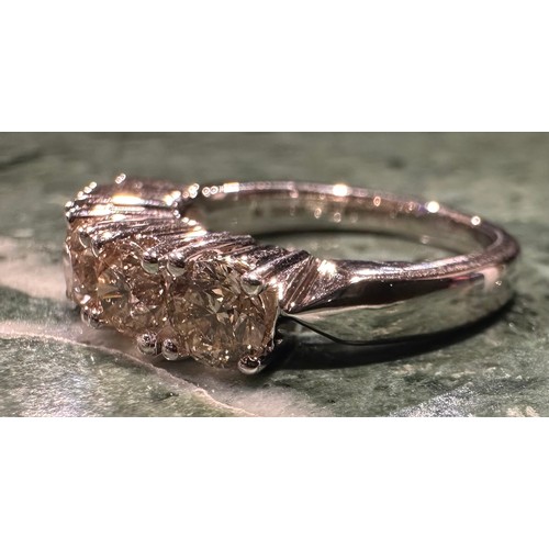 880 - A diamond ring, linear set with five round brilliant cut champagne diamonds, total estimated diamond... 