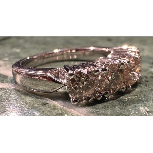 880 - A diamond ring, linear set with five round brilliant cut champagne diamonds, total estimated diamond... 