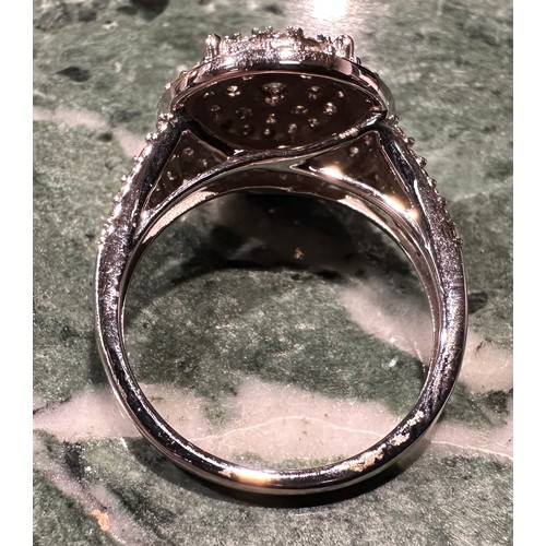 870 - A contemporary diamond cluster ring, multi level target crest set with forty eight round brilliant c... 