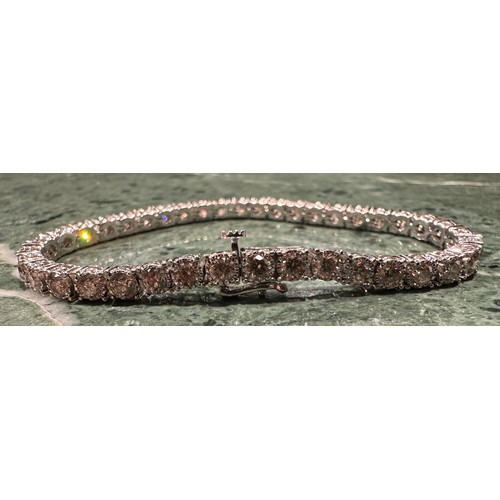 935 - An impressive diamond tennis bracelet, set with forty round brilliant cut diamonds, total estimated ... 