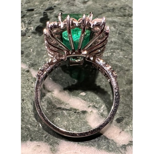 869 - A certified emerald and diamond cluster ring, central Zambian elongated octagonal step cut emerald, ... 