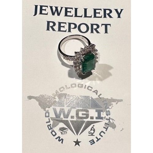 869 - A certified emerald and diamond cluster ring, central Zambian elongated octagonal step cut emerald, ... 