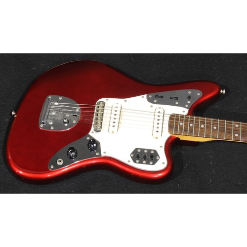 2557 - A Fender Jaguar electric guitar, made in Japan, serial number E555096, finished in deep red, 102cm l... 