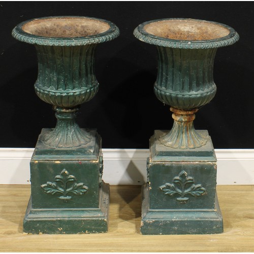 1518 - A pair of 19th century style cast iron fluted campana garden urns, each with egg-and-dart rim, recon... 