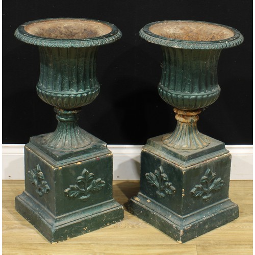 1518 - A pair of 19th century style cast iron fluted campana garden urns, each with egg-and-dart rim, recon... 