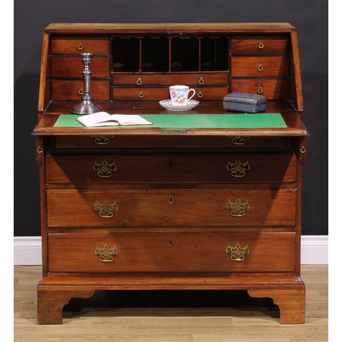 1301 - A George III mahogany bureau, fall front enclosing small drawers and pigeonholes, above four long gr... 