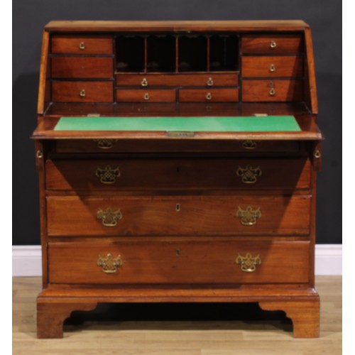 1301 - A George III mahogany bureau, fall front enclosing small drawers and pigeonholes, above four long gr... 