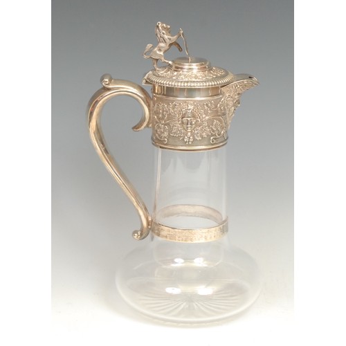 699 - A Victorian silver and clear glass claret jug, star cut base, deep collar embossed with Bacchus mask... 