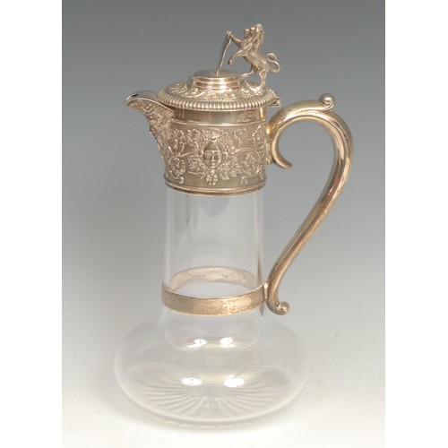 699 - A Victorian silver and clear glass claret jug, star cut base, deep collar embossed with Bacchus mask... 