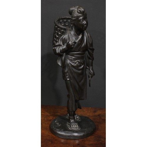 467 - Japanese School (Meiji period), a dark patinated bronze, of a young girl returning from the fields, ... 