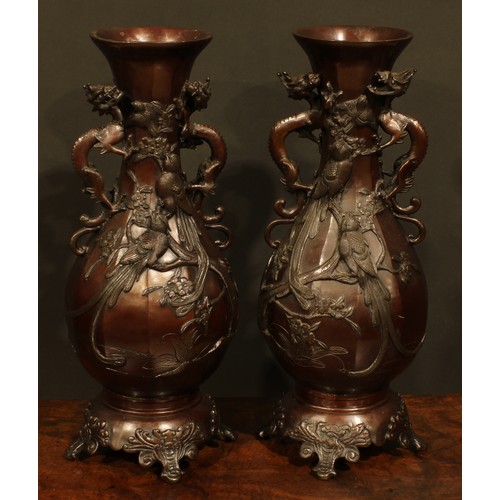 375 - A pair of Japanese brown patinated bronze panelled baluster vases, cast with song birds and blossomi... 