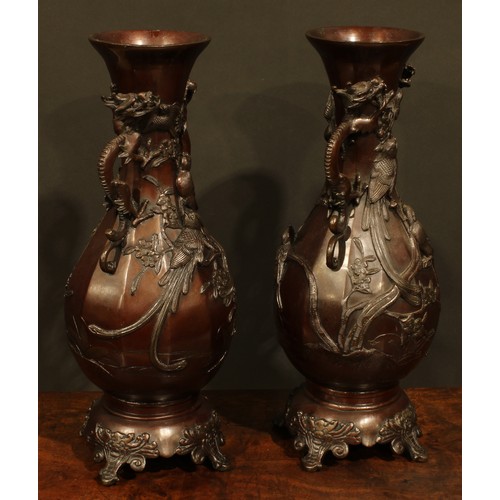 375 - A pair of Japanese brown patinated bronze panelled baluster vases, cast with song birds and blossomi... 