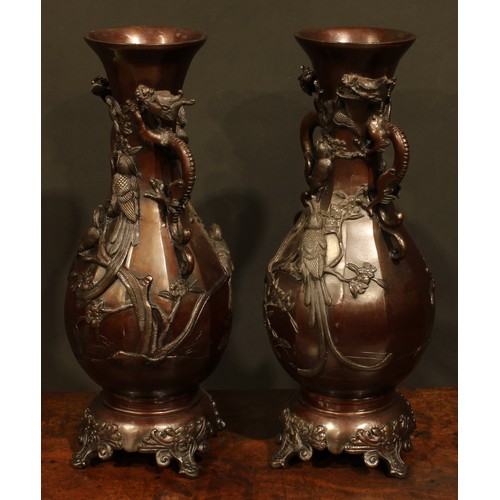 375 - A pair of Japanese brown patinated bronze panelled baluster vases, cast with song birds and blossomi... 