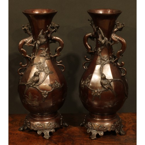 375 - A pair of Japanese brown patinated bronze panelled baluster vases, cast with song birds and blossomi... 