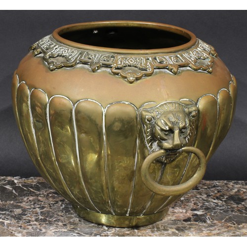 401 - A Chinese brass fluted ovoid jardiniere, applied pierced lappet border, loose ring lion mask handles... 