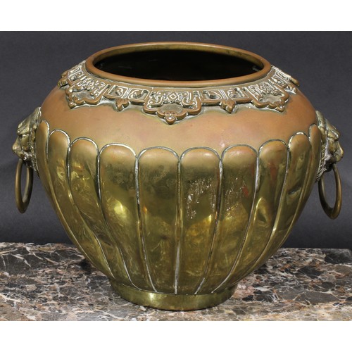 401 - A Chinese brass fluted ovoid jardiniere, applied pierced lappet border, loose ring lion mask handles... 