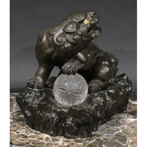 436 - A Chinese brown patinated bronze censer and cover, cast as a temple lion, his paw resting on a glass... 