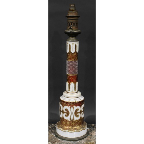 288 - A Bohemian overlaid glass table oil lamp, in the Islamic and Orientalist taste, decorated in gilt wi... 