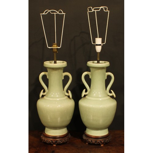 355 - A pair of Chinese celadon ovoid vases, fitted as table lamps, ruyi sceptre handles, hardwood bases, ... 