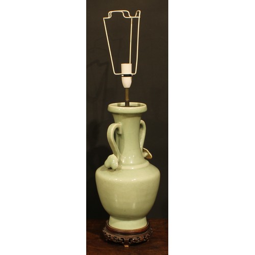 355 - A pair of Chinese celadon ovoid vases, fitted as table lamps, ruyi sceptre handles, hardwood bases, ... 