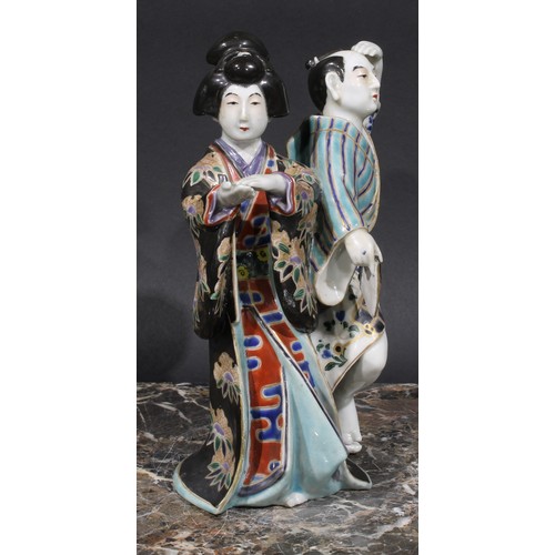 461 - A Japanese porcelain figure group, a geisha and a man holding a fan, 22cm high, early 20th century