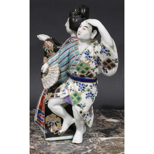 461 - A Japanese porcelain figure group, a geisha and a man holding a fan, 22cm high, early 20th century