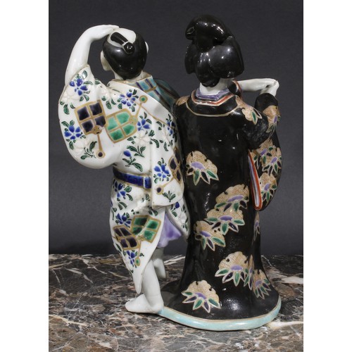 461 - A Japanese porcelain figure group, a geisha and a man holding a fan, 22cm high, early 20th century