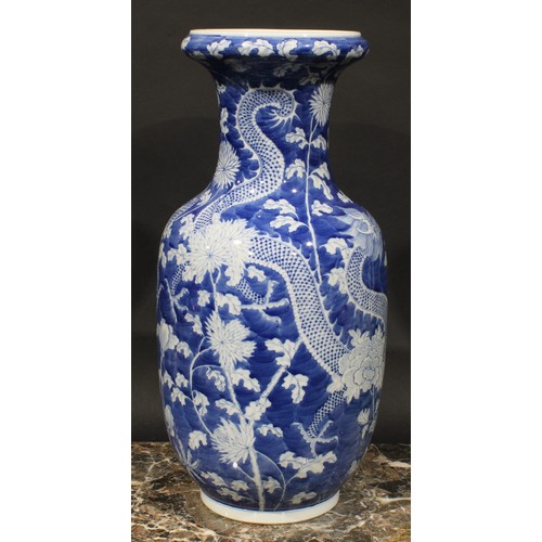 413 - A Chinese ovoid vase, painted in tones of underglaze blue with dragons amogst peonies and foliage, o... 