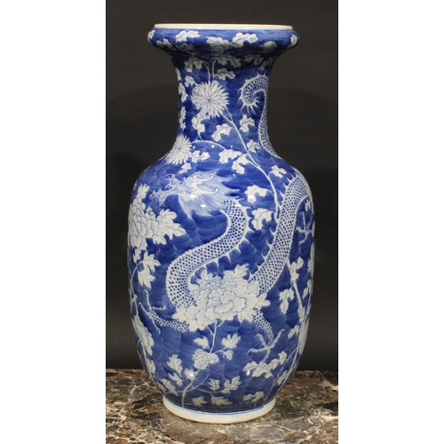 413 - A Chinese ovoid vase, painted in tones of underglaze blue with dragons amogst peonies and foliage, o... 