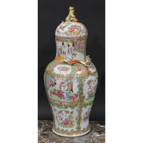 352 - A pair of Cantonese baluster vases and covers, painted in the famille rose palette with figures, bir... 