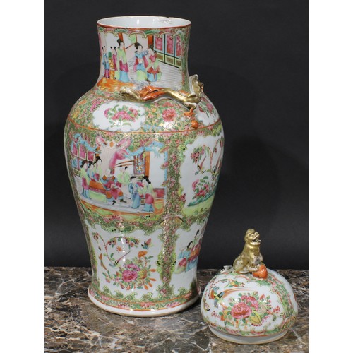 352 - A pair of Cantonese baluster vases and covers, painted in the famille rose palette with figures, bir... 