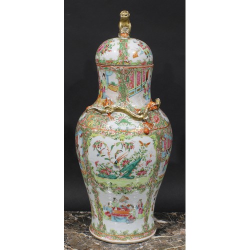 352 - A pair of Cantonese baluster vases and covers, painted in the famille rose palette with figures, bir... 