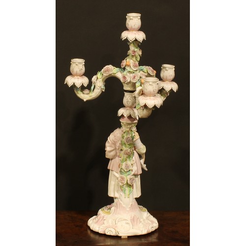 265 - A pair of Continental porcelain four-light table candelabra, figural bases, the branches encrusted w... 