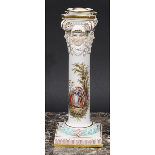 268 - A pair of Meissen columnar candlesticks, each moulded with masks and painted with a courting couple,... 