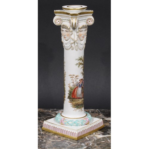 268 - A pair of Meissen columnar candlesticks, each moulded with masks and painted with a courting couple,... 