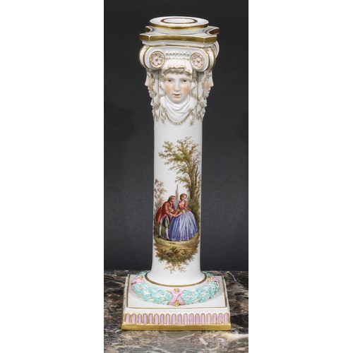 268 - A pair of Meissen columnar candlesticks, each moulded with masks and painted with a courting couple,... 