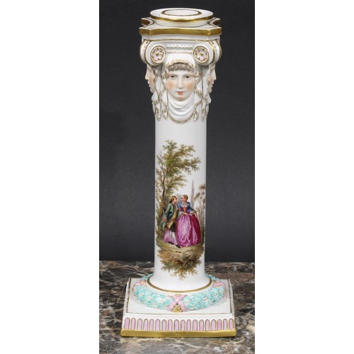 268 - A pair of Meissen columnar candlesticks, each moulded with masks and painted with a courting couple,... 