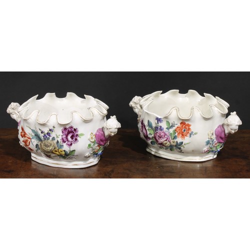 264 - A pair of 19th century Continental porcelain Monteiths, painted with Deutsche blumen, figural handle... 