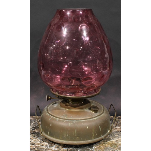 2075 - A late 19th century brass heater lamp, coin dot cranberry glass shade, 41cm high