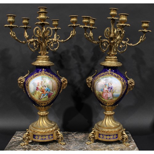 2083 - A pair of 19th century gilt metal and porcelain six light candelabra, acanthus scroll branches, camp... 