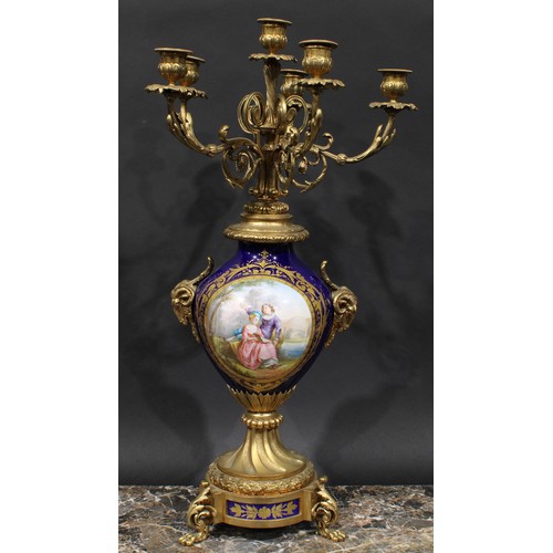 2083 - A pair of 19th century gilt metal and porcelain six light candelabra, acanthus scroll branches, camp... 